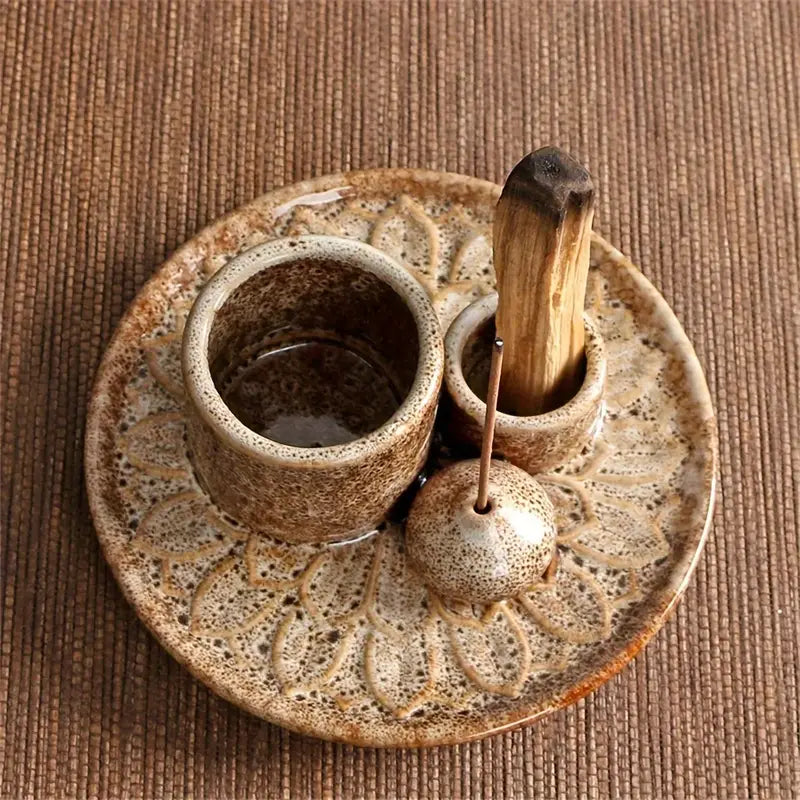 Ceramic incense burner with a stick on a textured brown surface