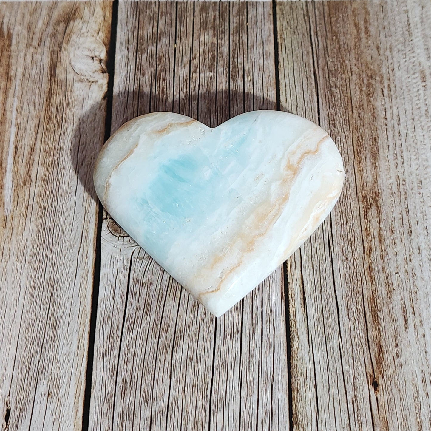Heart-shaped stone on a wooden surface