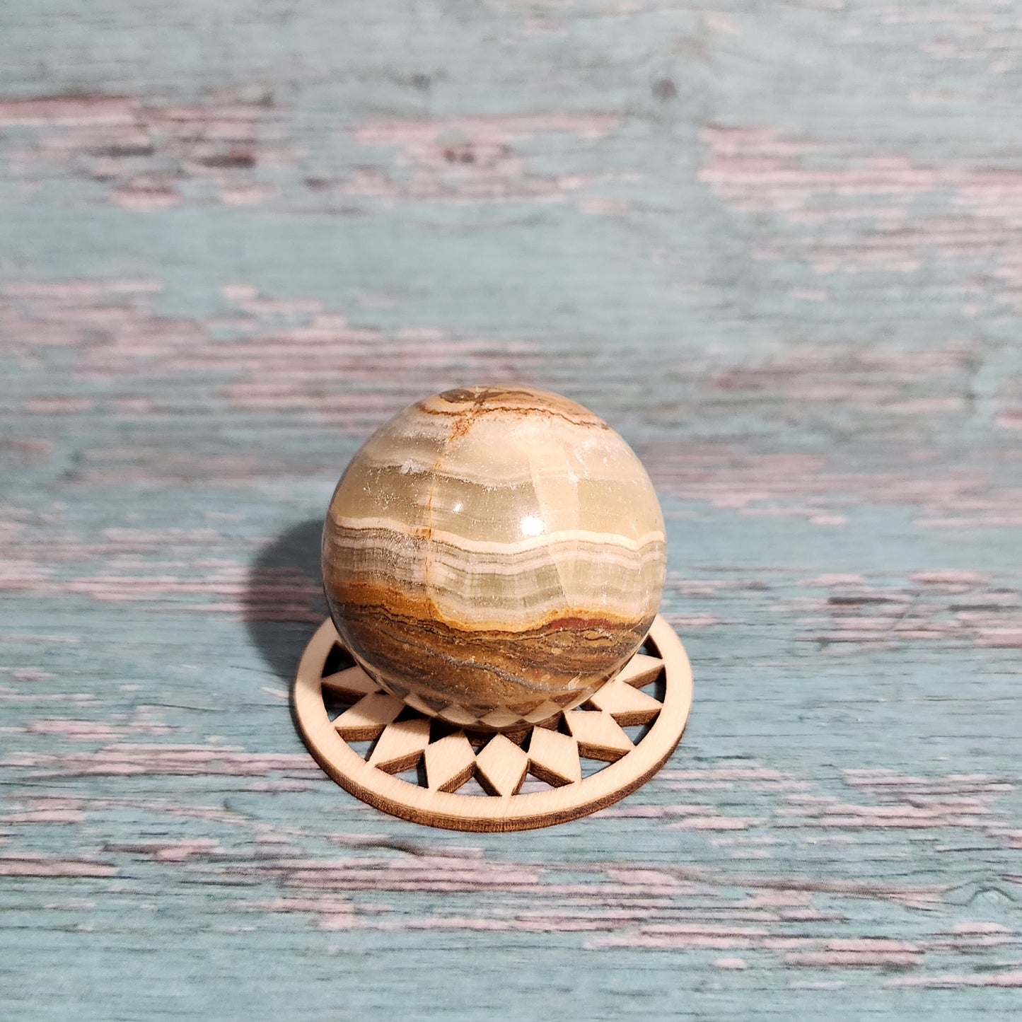 Decorative wooden knob on a textured blue door