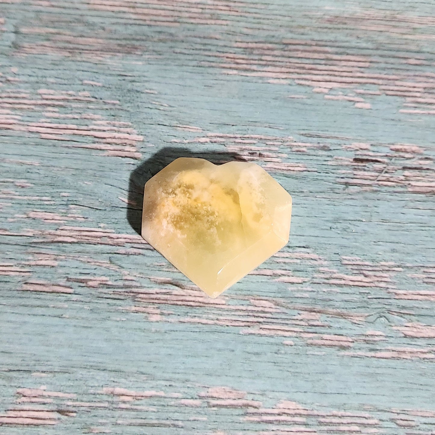 Yellow crystal on a textured blue surface