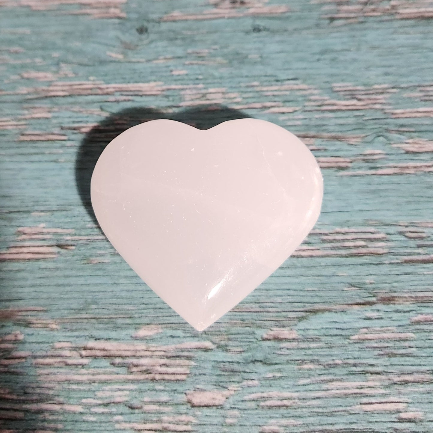 Heart-shaped object on a textured blue surface