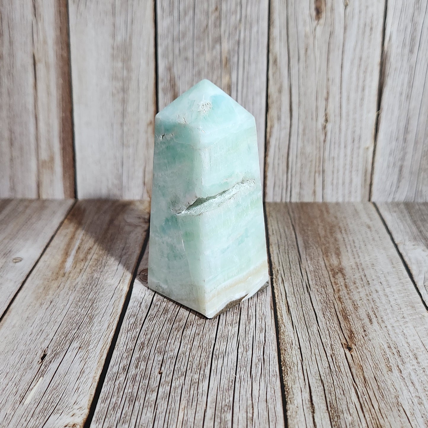 Teal crystal on a wooden surface