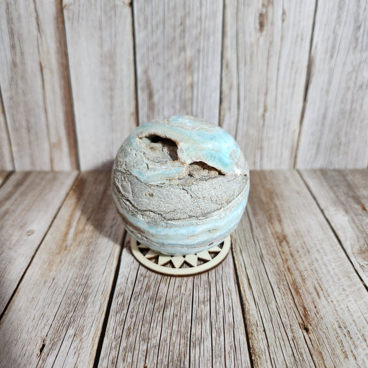 Decorative turquoise knob on a wooden surface