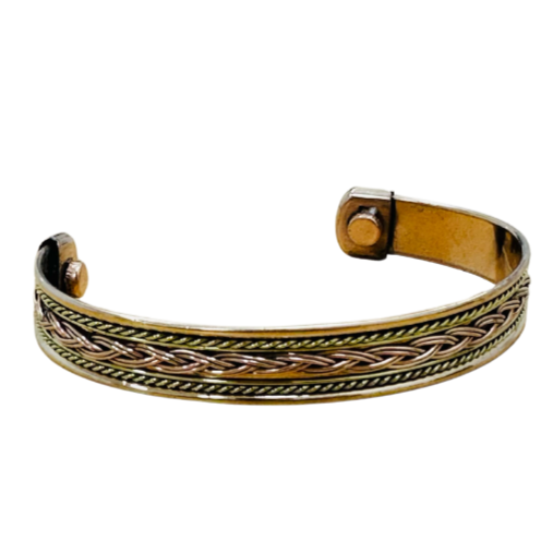Brass bangle with braided design on a white background