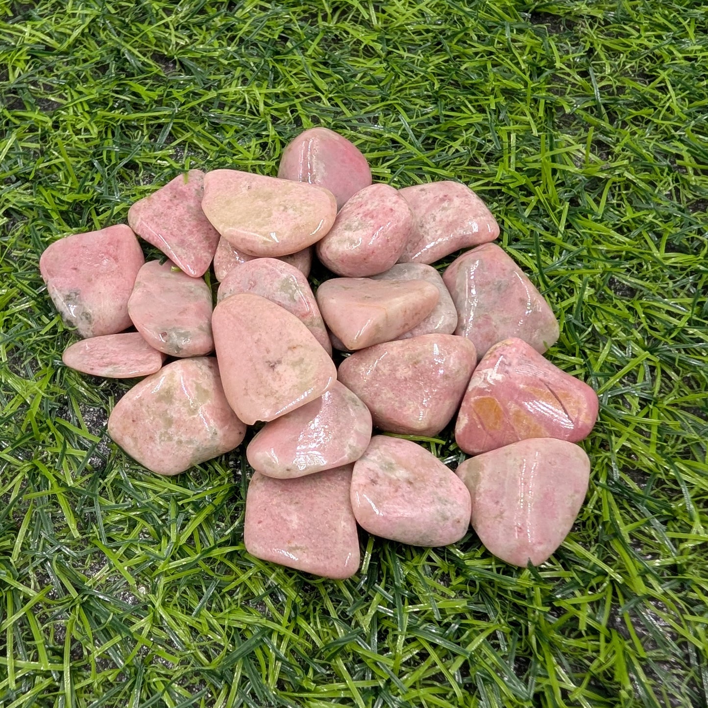 Pink stones on a green grass background