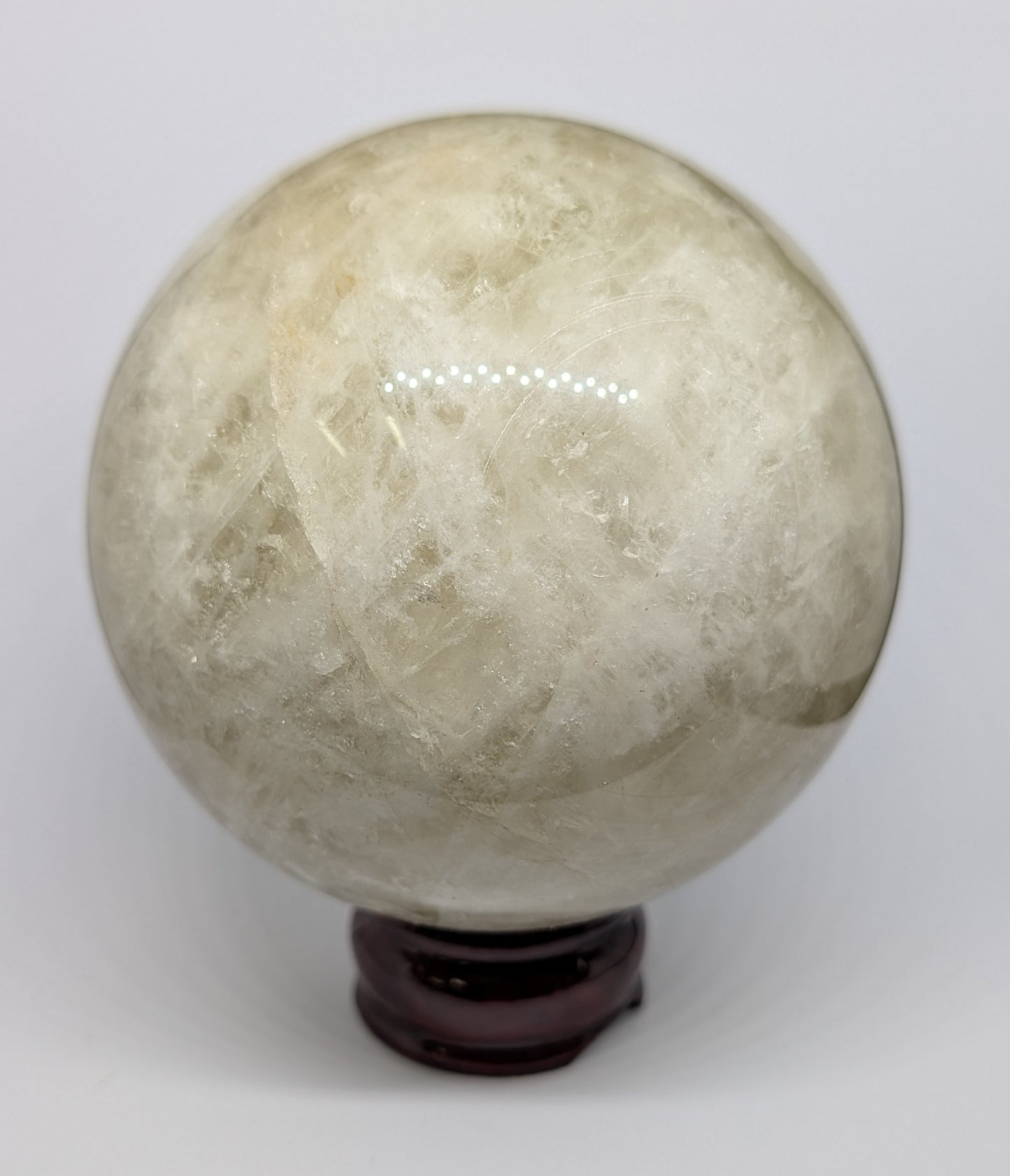 Crystal ball on a stand against a white background