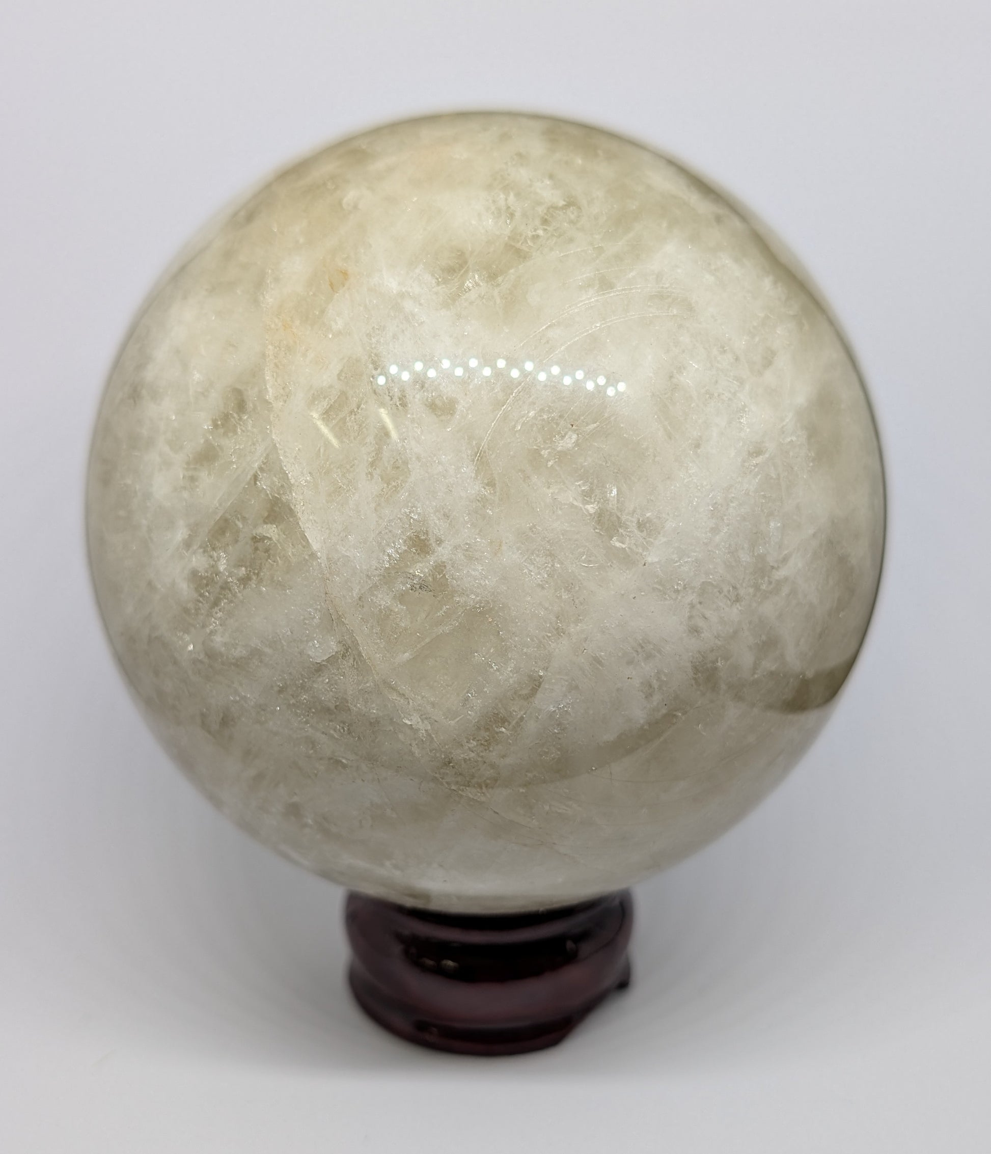 Crystal ball on a stand against a white background