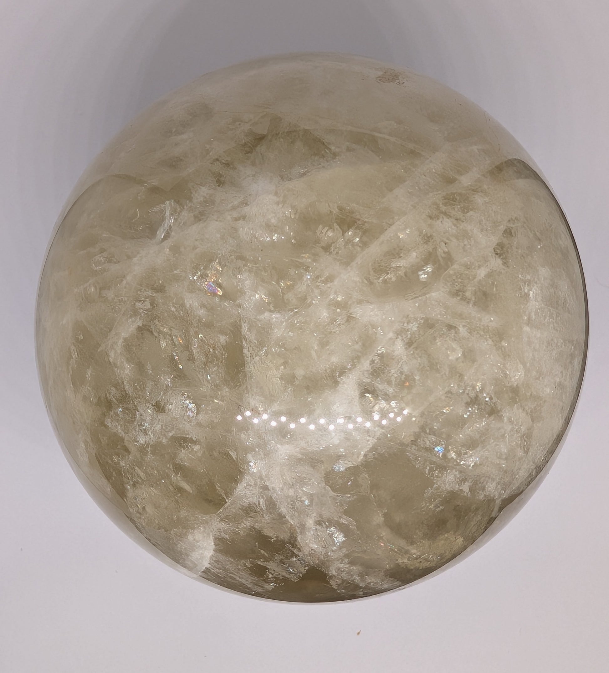 Round stone with a textured surface on a white background
