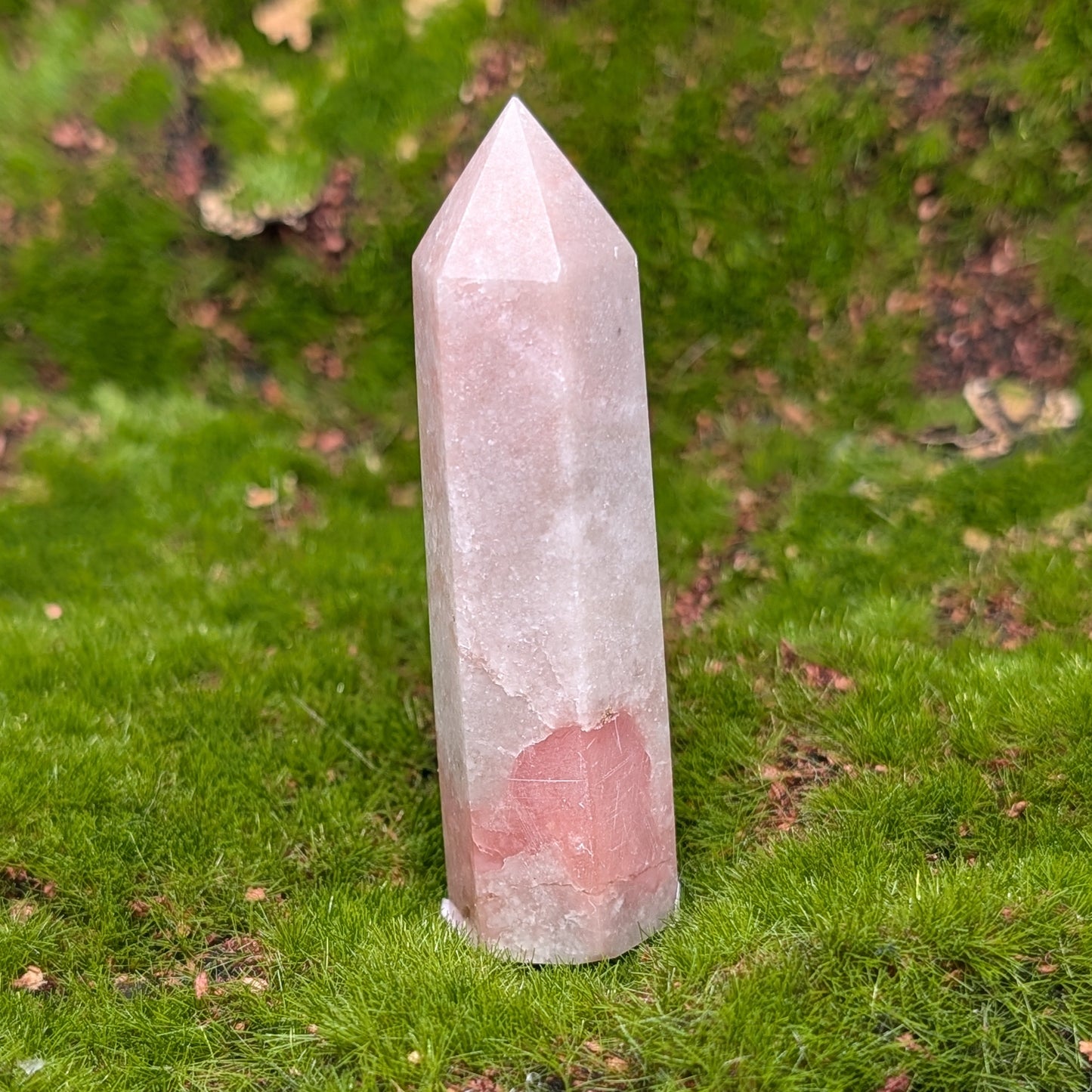 Crystal tower on a green mossy surface