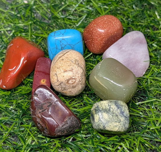 Assorted colorful stones on a grassy background