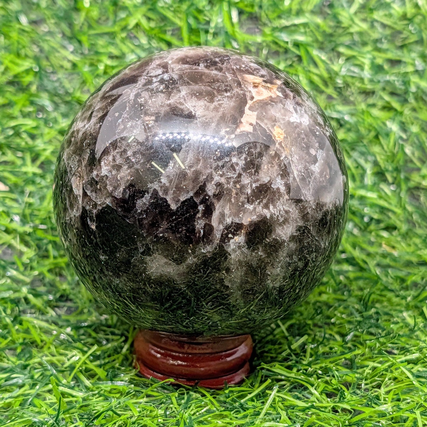 Decorative stone sphere on a grassy background