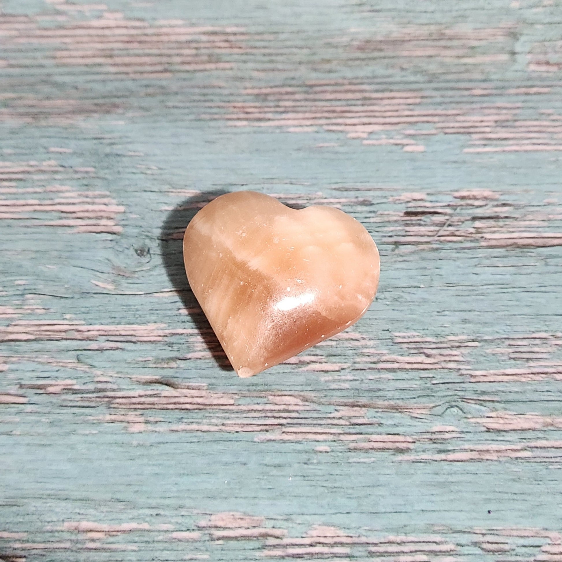 Small beige stone on a textured blue surface