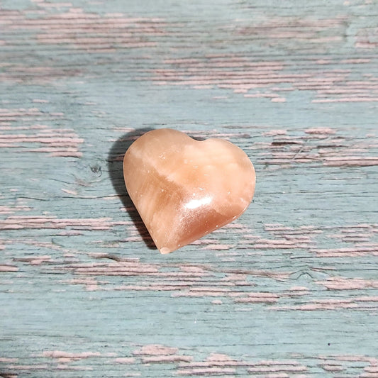 Small beige stone on a textured blue surface