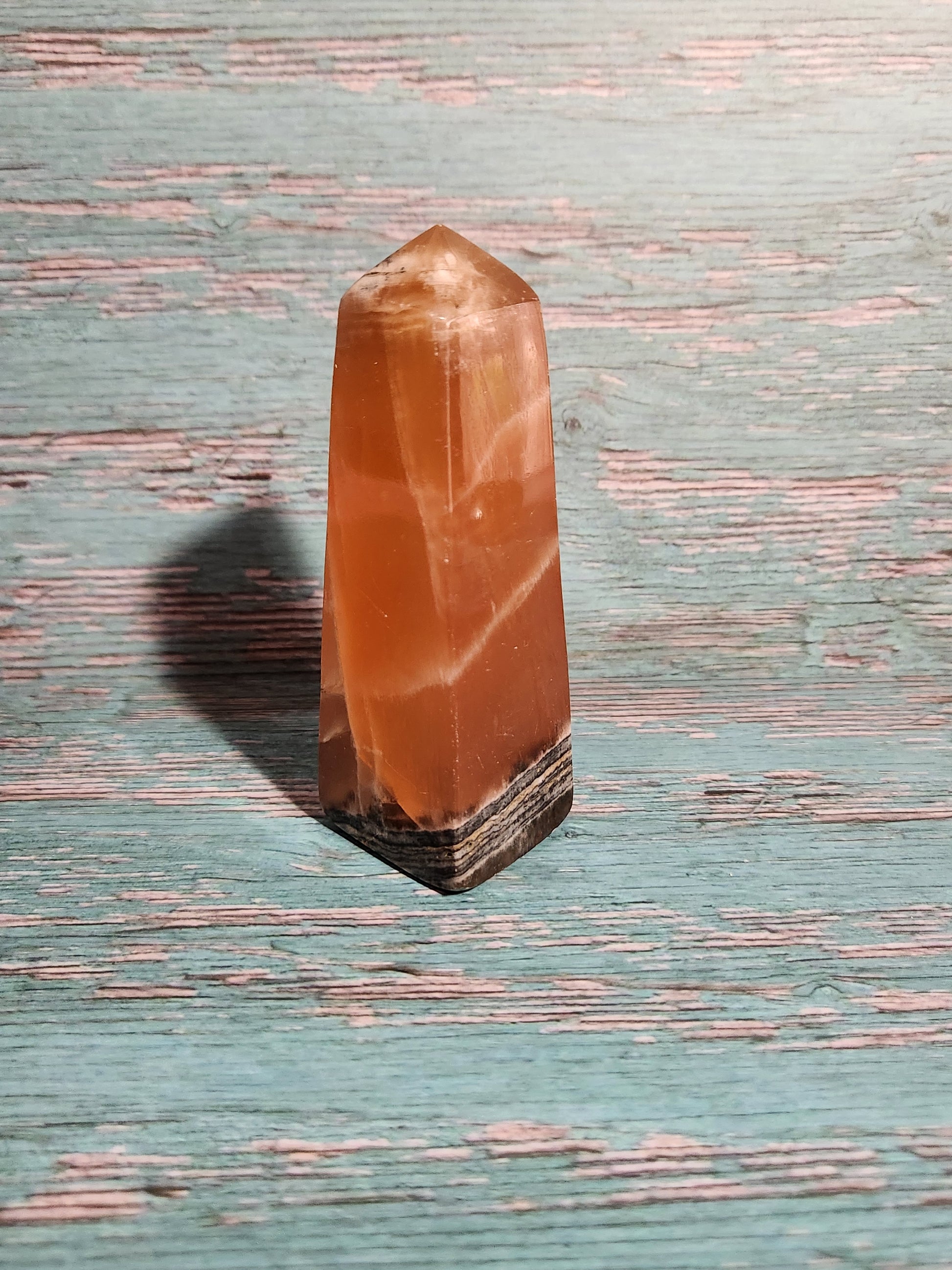 Orange crystal on a textured blue surface