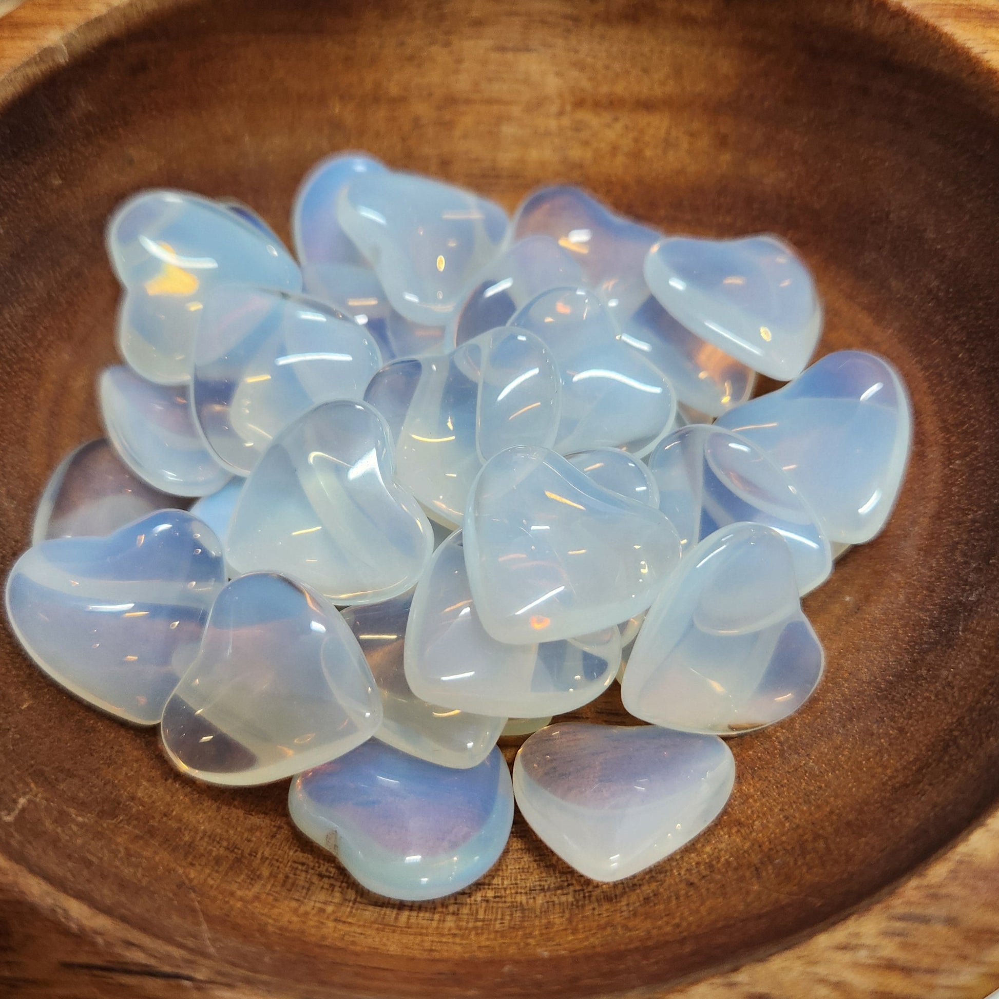 Opaline stones on a wooden plate with a blurred background