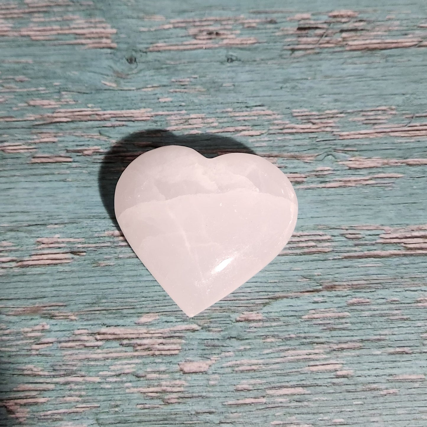 Heart-shaped object on a textured blue surface