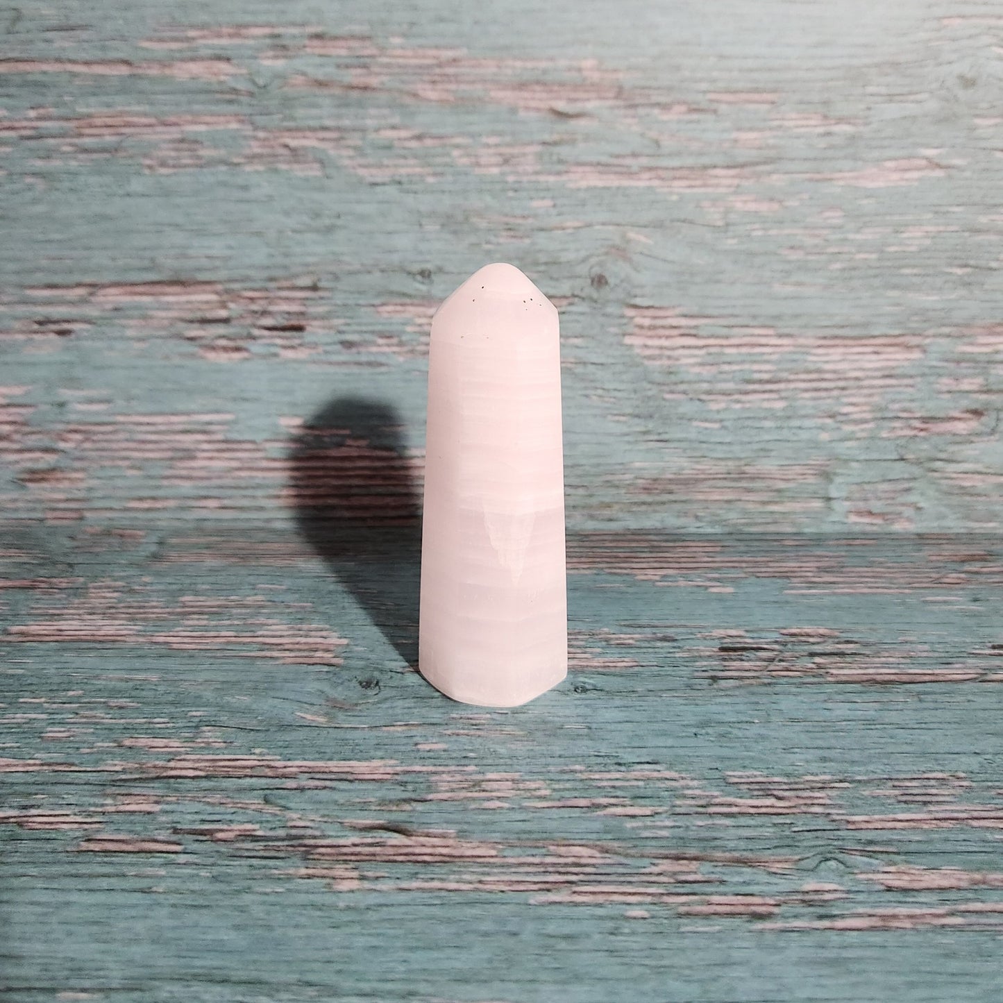 Rectangular pink object on a textured green surface