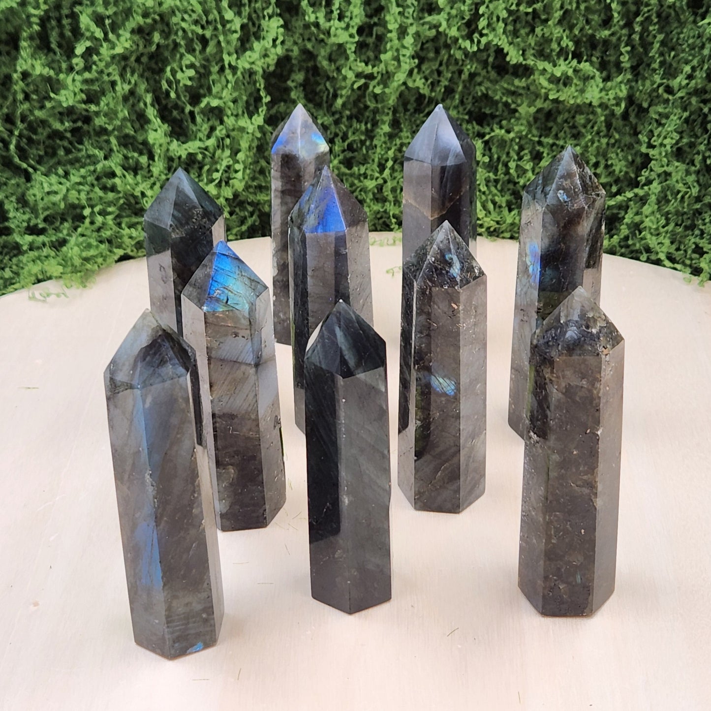 Set of crystal points on a white surface with greenery in the background