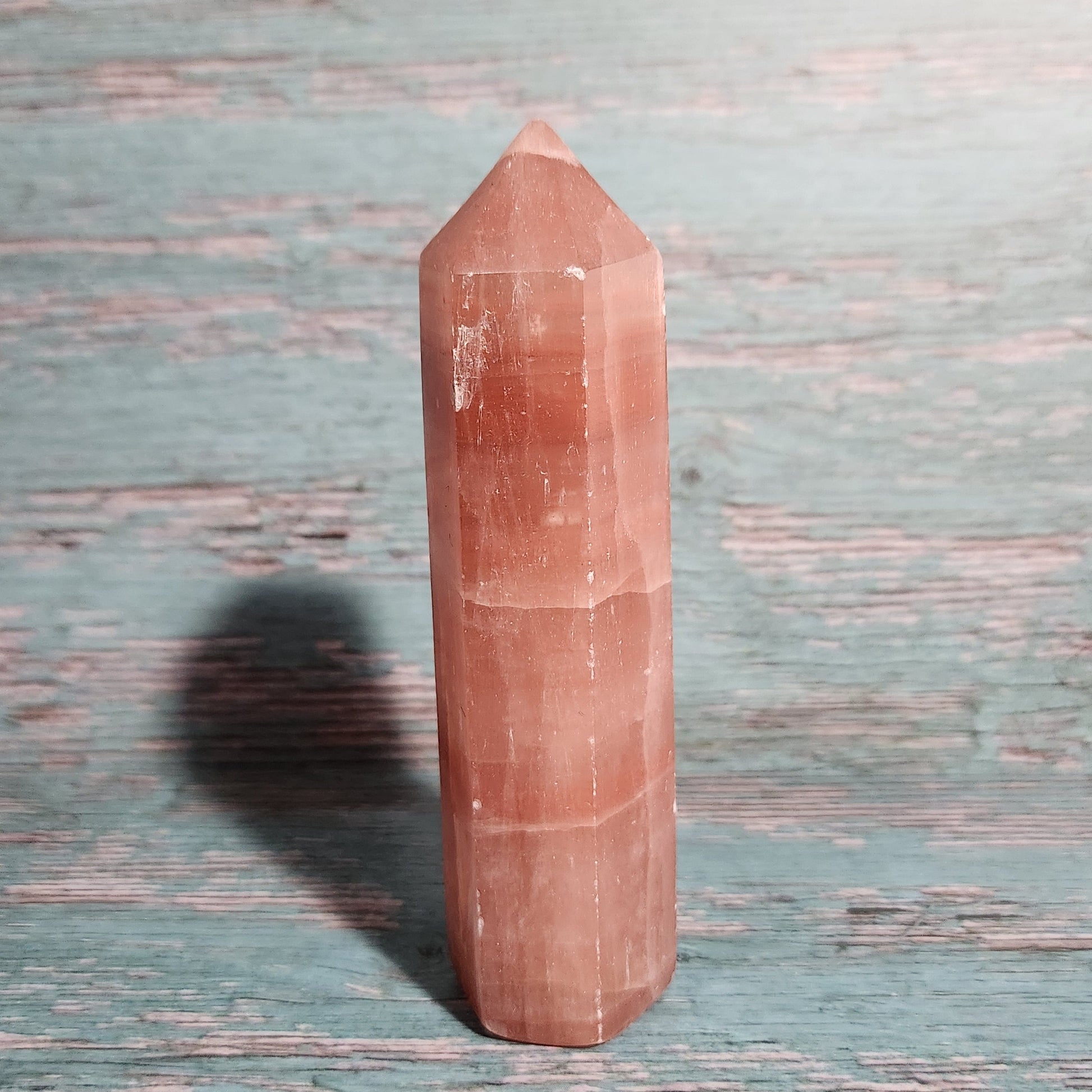 Rectangular pink crystal on a textured blue surface