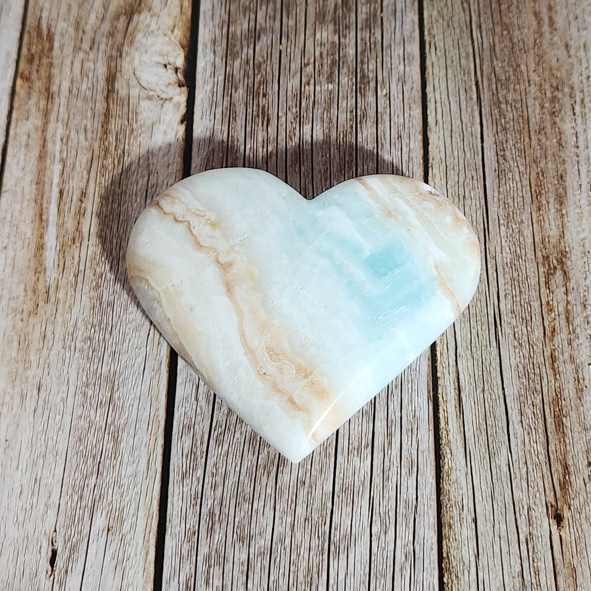 Heart-shaped stone on a wooden surface