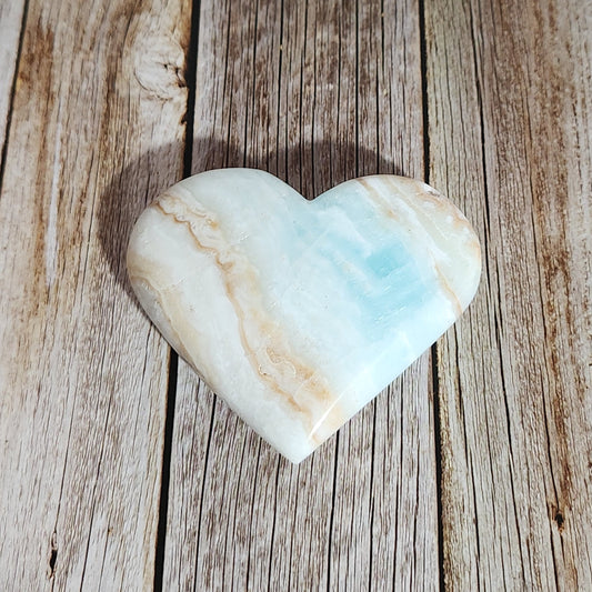 Heart-shaped stone on a wooden surface