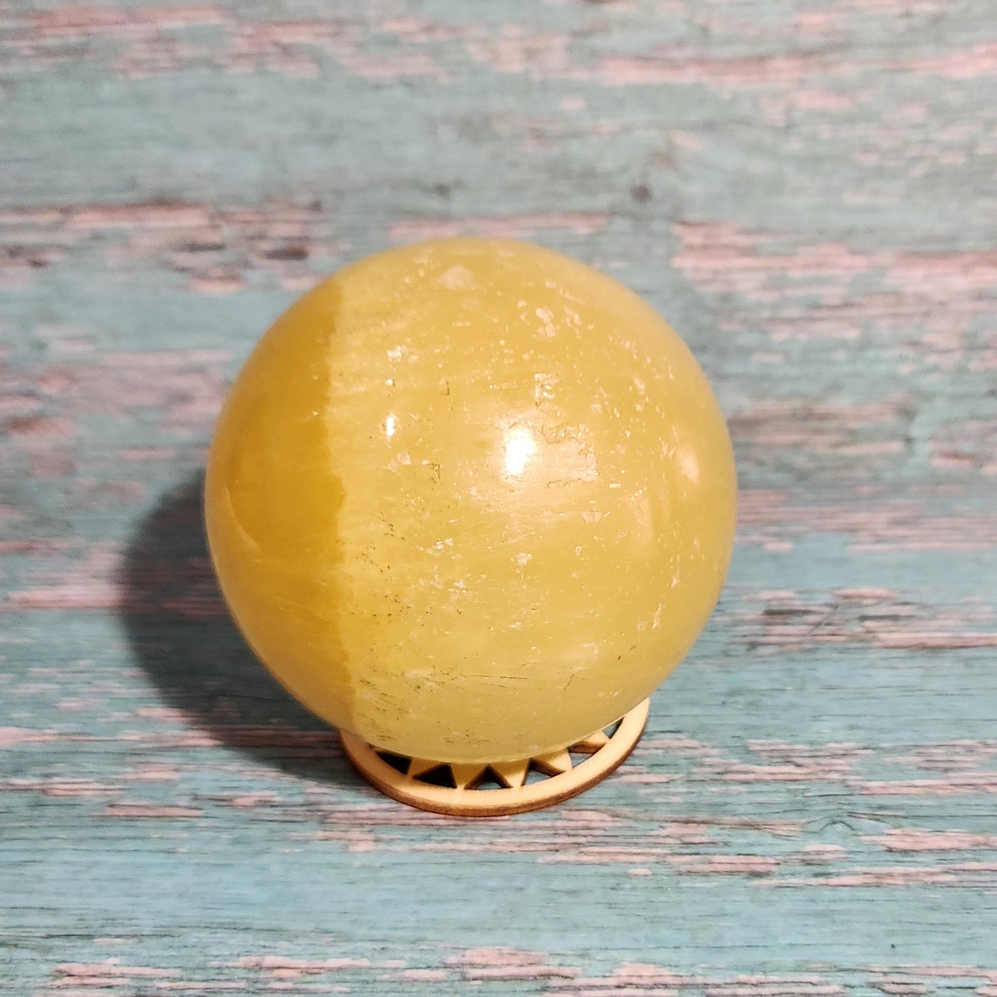 Yellow spherical object on a textured blue surface