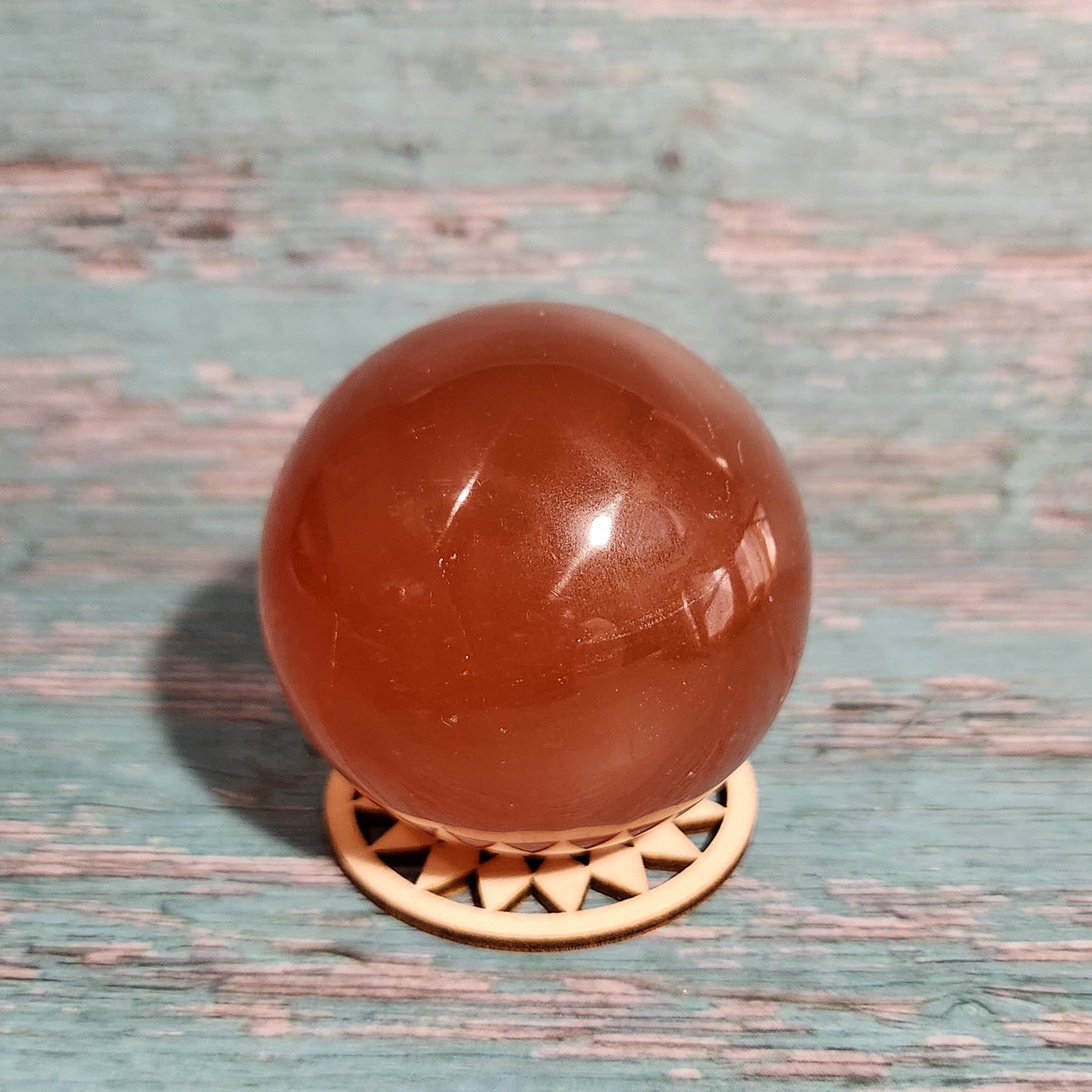 Brown spherical doorknob on a textured blue door