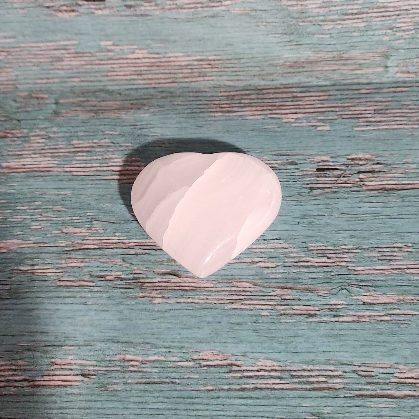 Pink object on a textured green surface