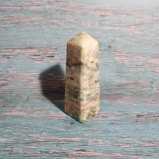 Rectangular stone object on a textured blue surface