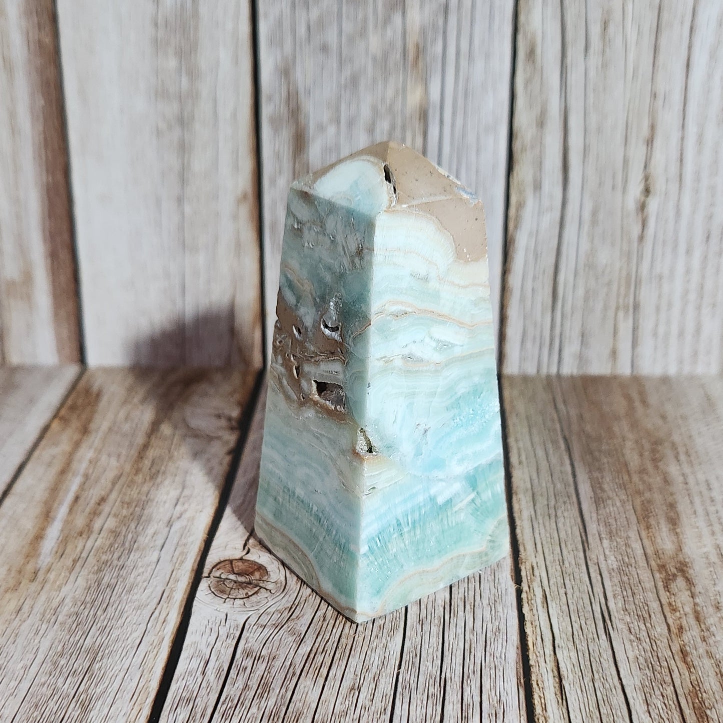 Close-up of a green stone block on a wooden surface