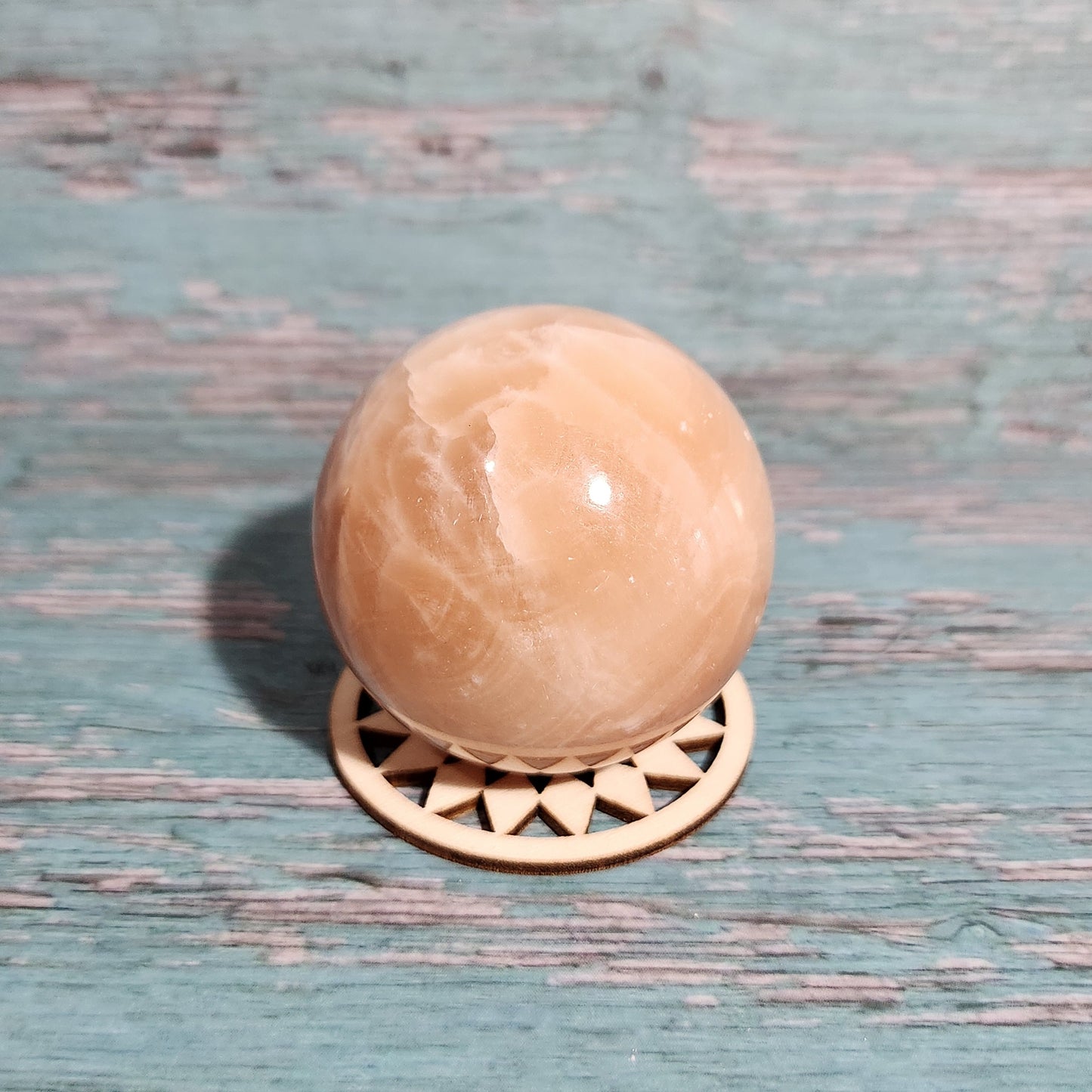 Decorative door handle with a beige knob on a textured blue door