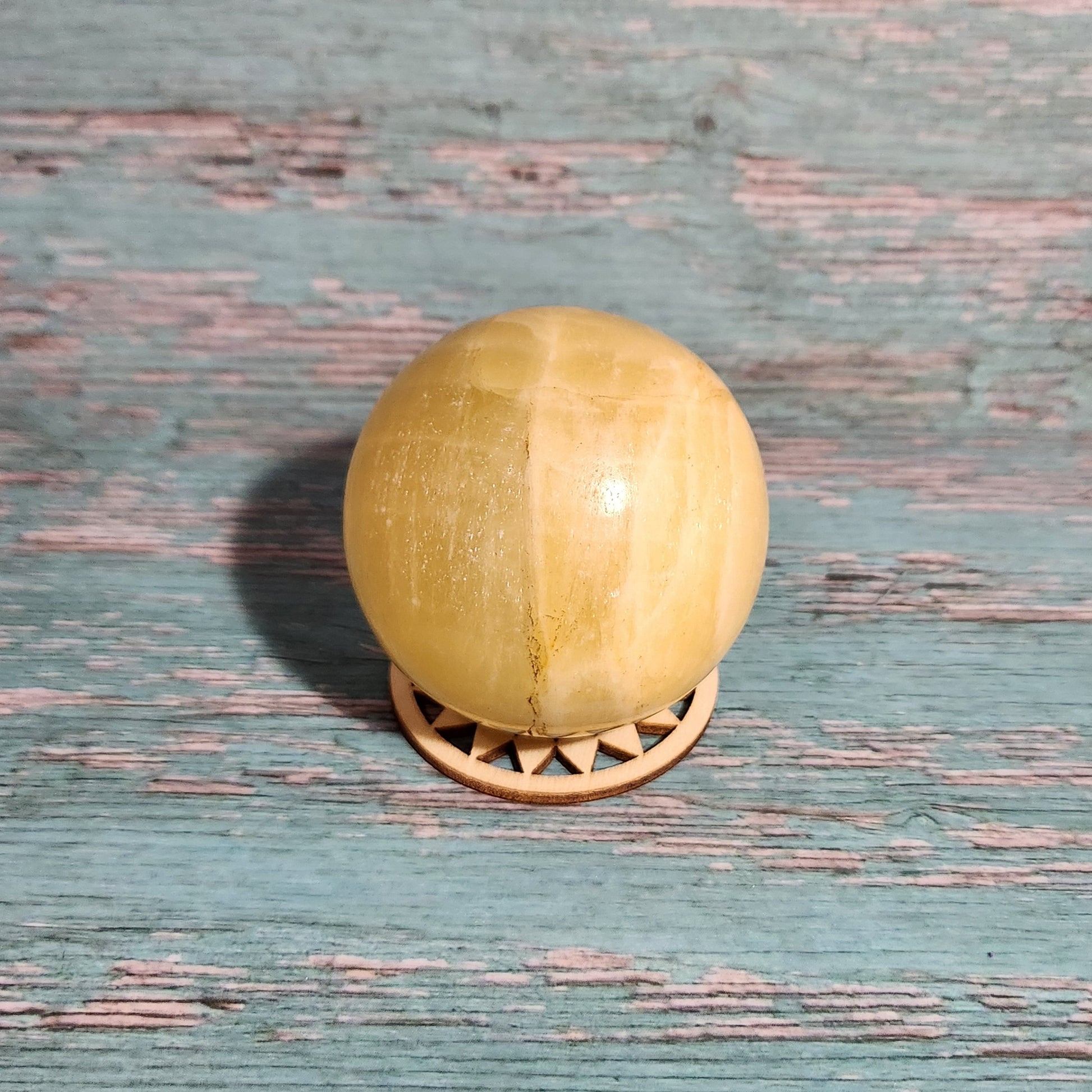 Wooden door handle on a textured blue door