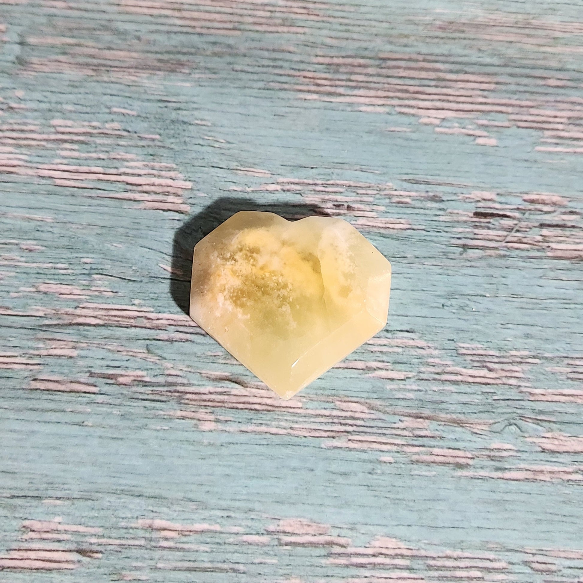 Yellow crystal on a textured blue surface
