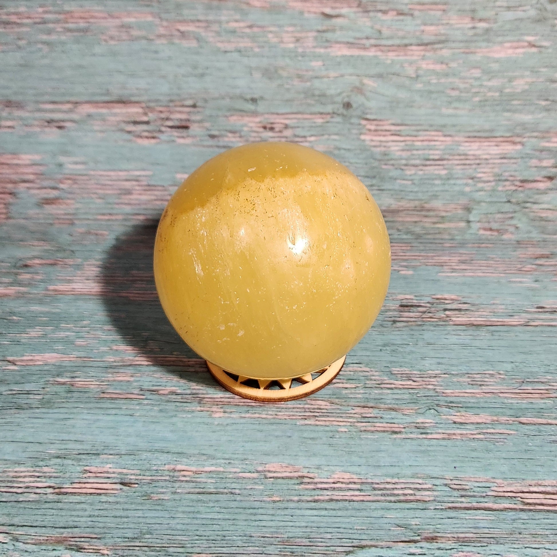 Yellow door knob on a textured blue door