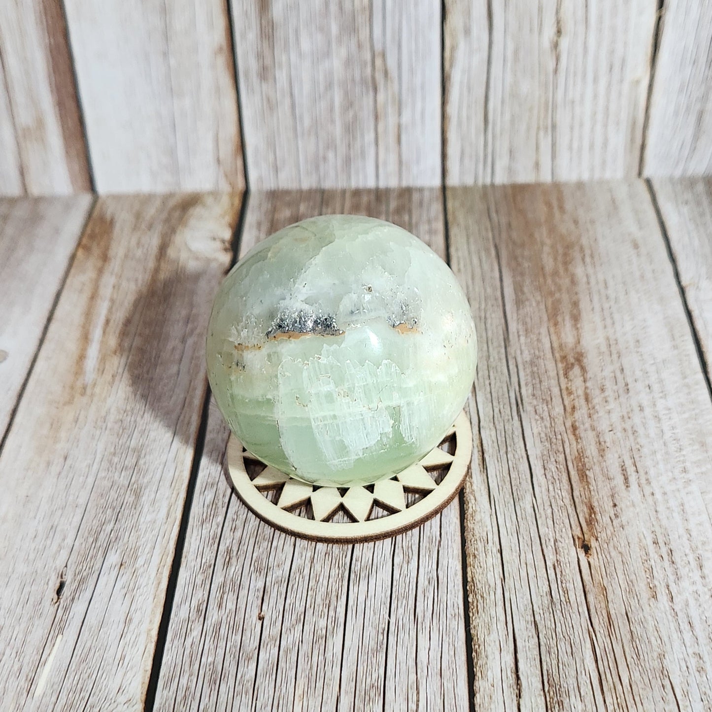 Decorative green knob on a wooden door