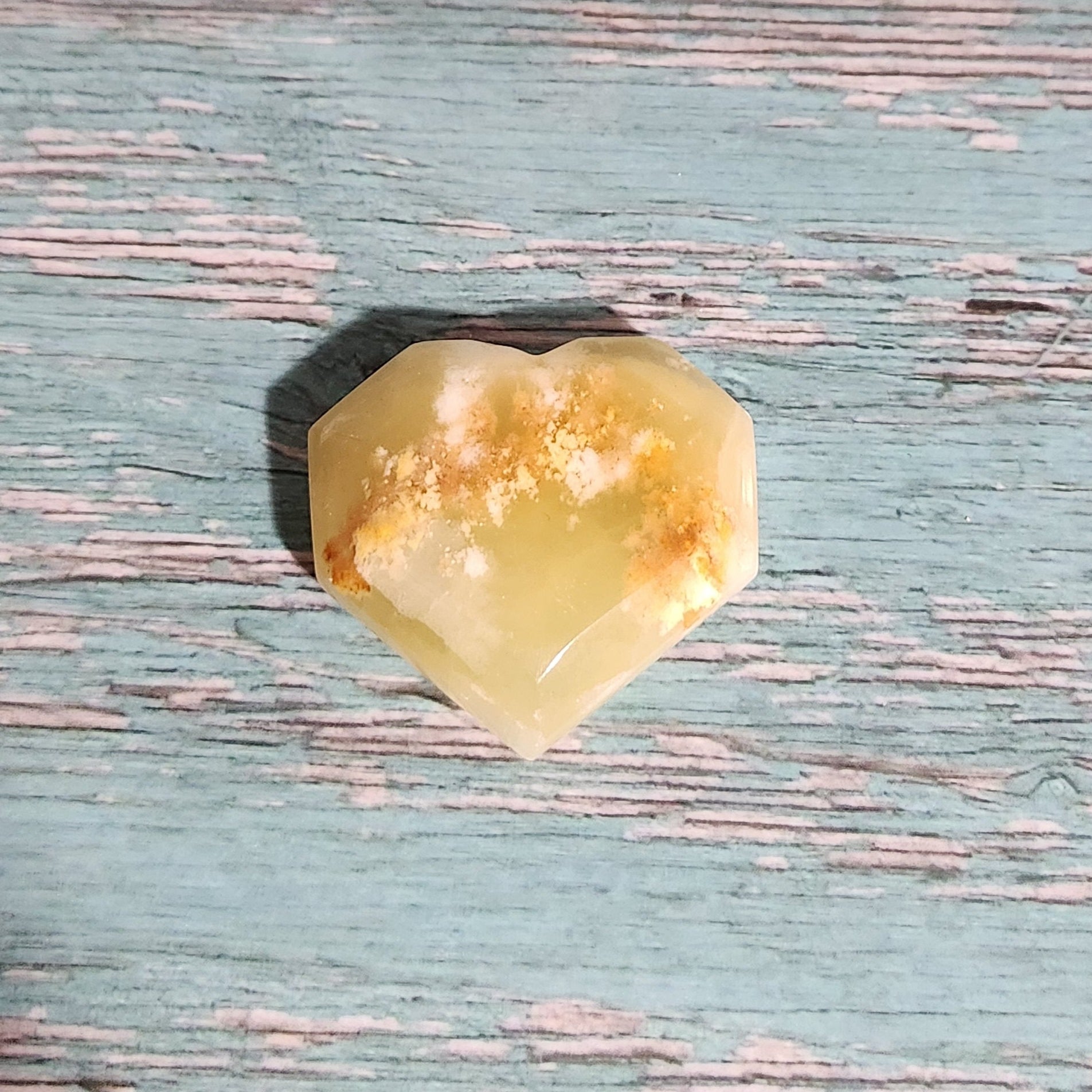Yellow stone on a textured blue surface