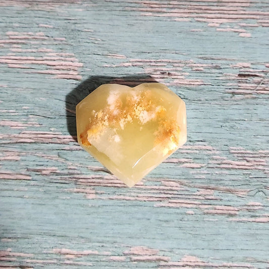 Yellow stone on a textured blue surface