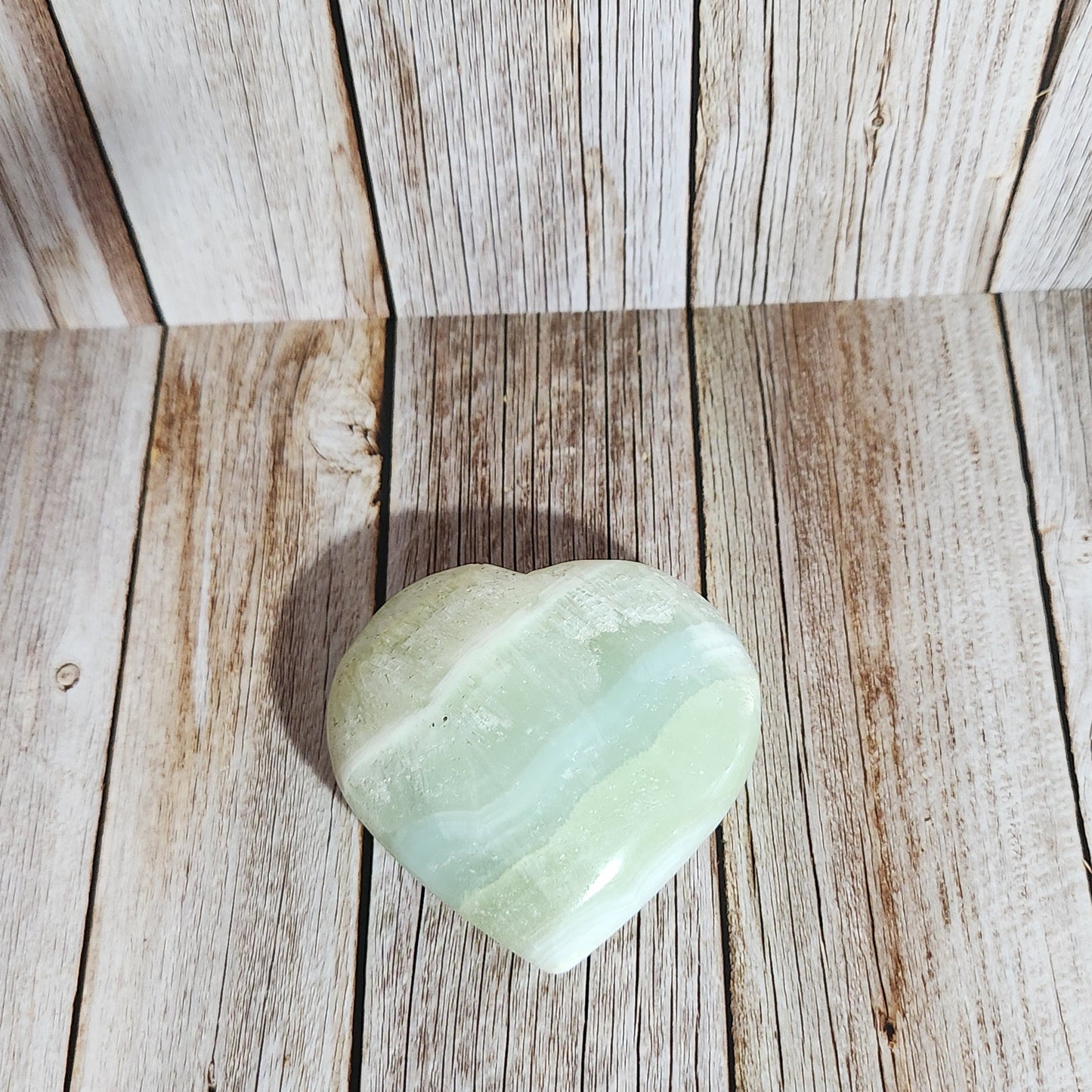 Light green stone on a wooden surface