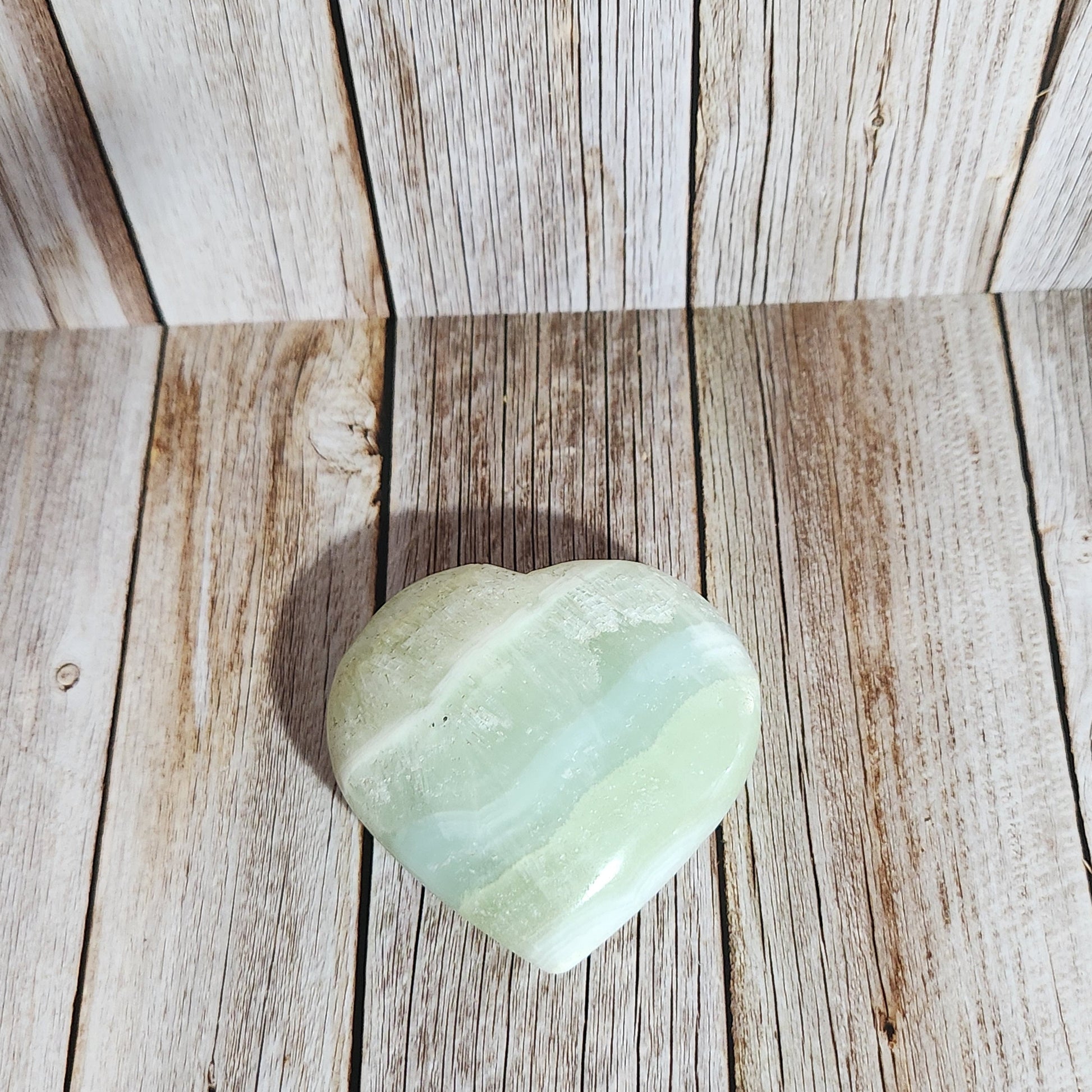 Light green stone on a wooden surface