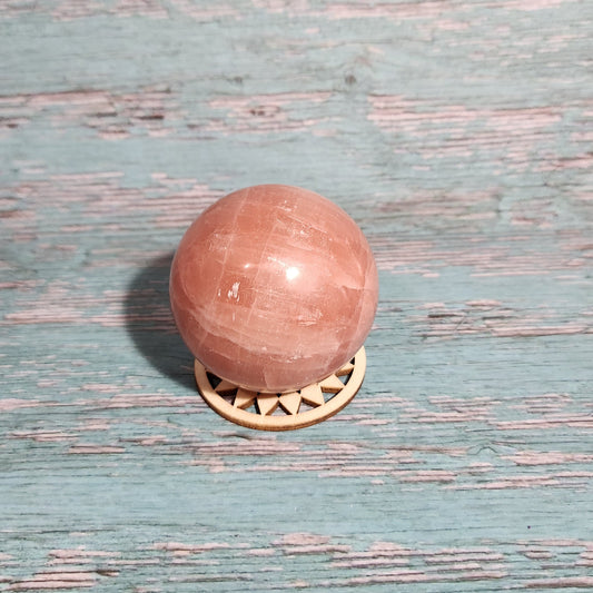 Pink door knob on a textured blue door