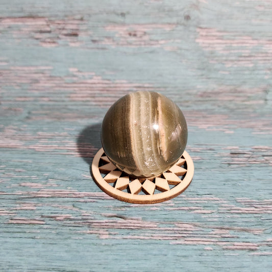 Decorative brass door handle on a textured wooden door