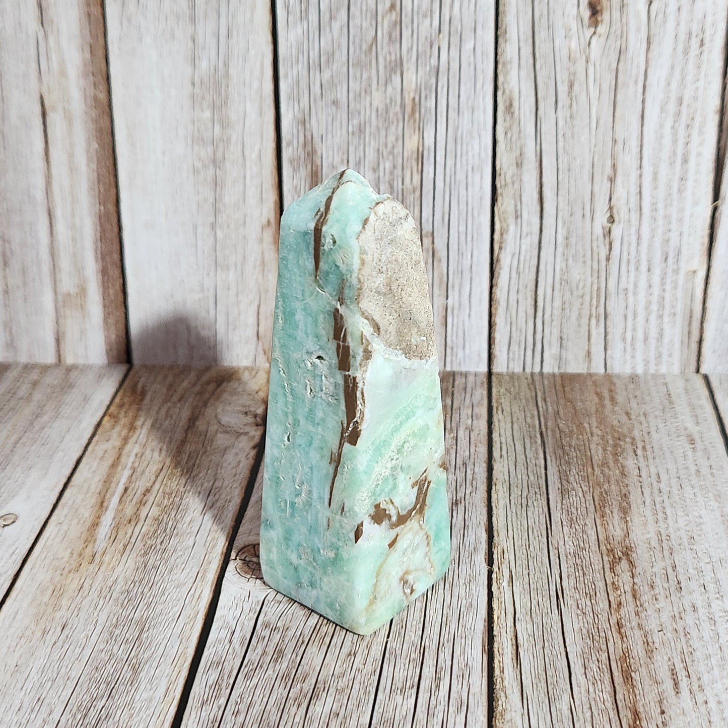Turquoise crystal on a wooden surface