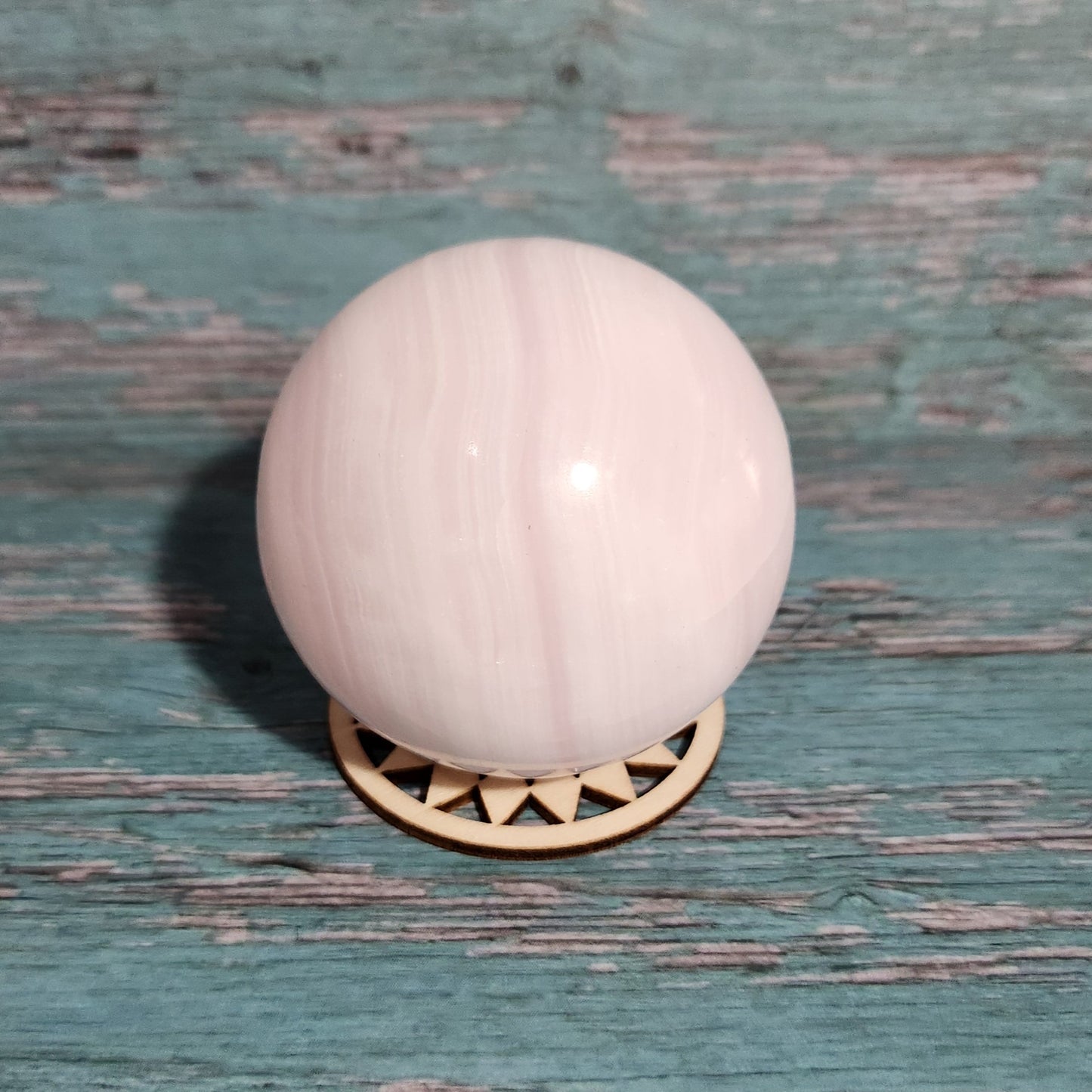 White spherical knob on a textured green door