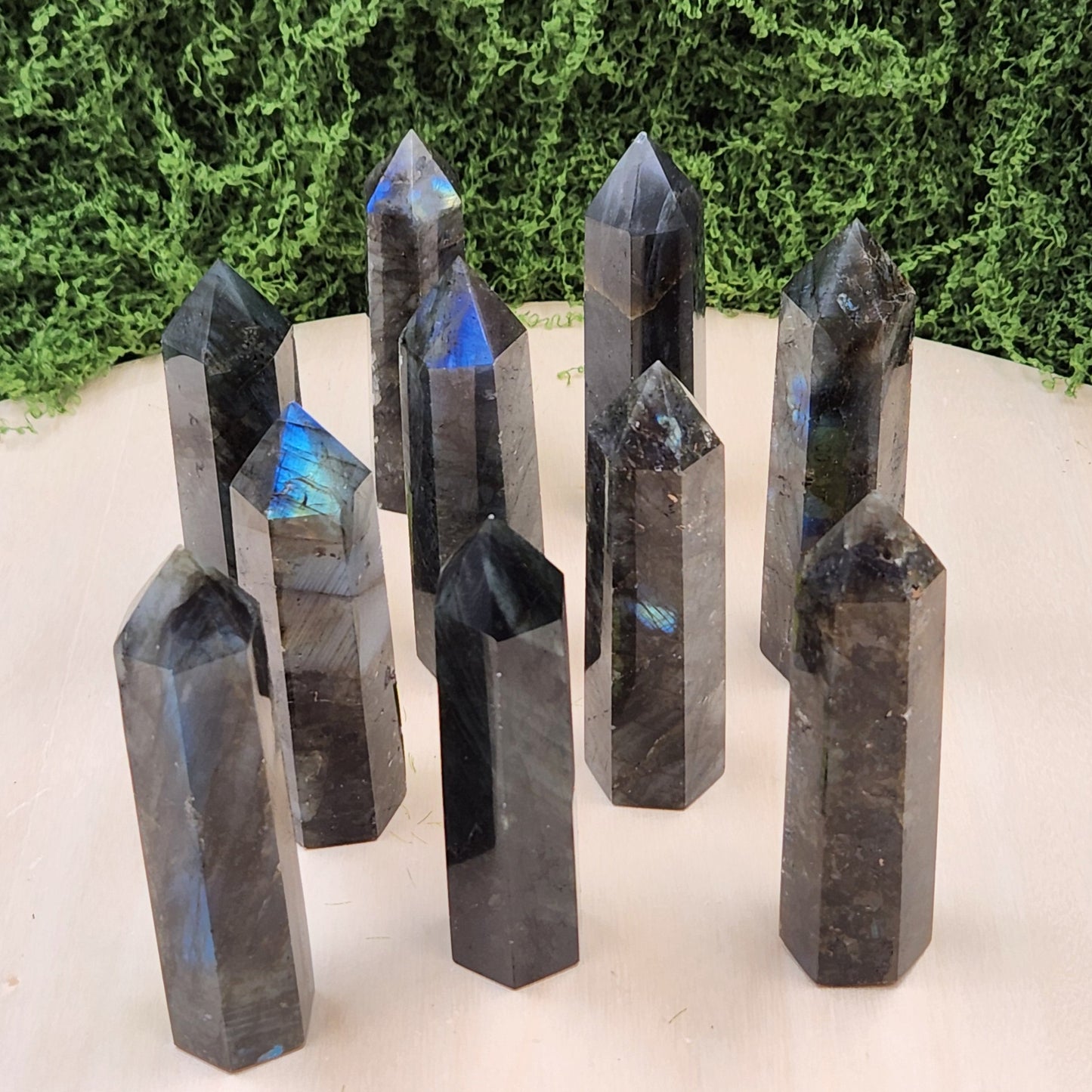 Set of crystal points on a white surface with greenery in the background