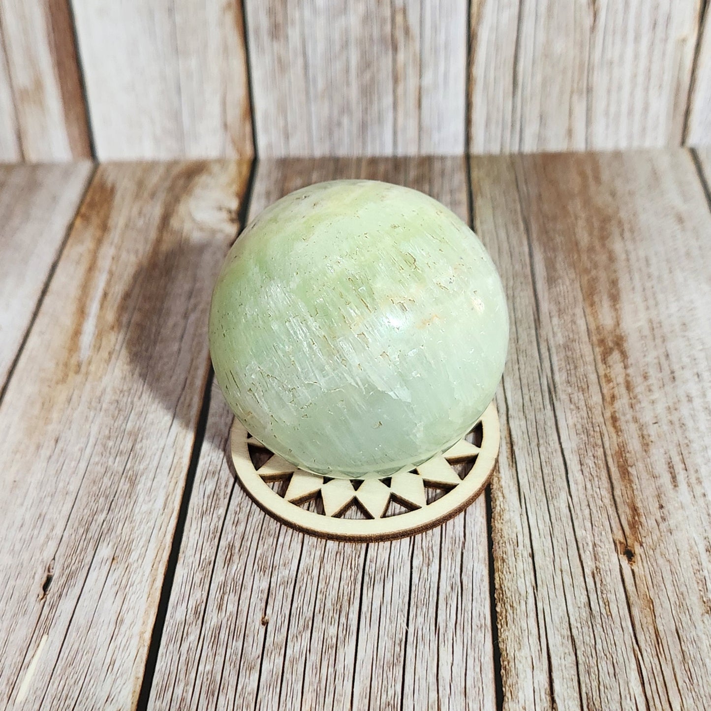 Green bath bomb on a wooden surface