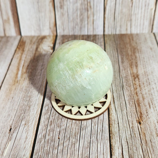 Green bath bomb on a wooden surface
