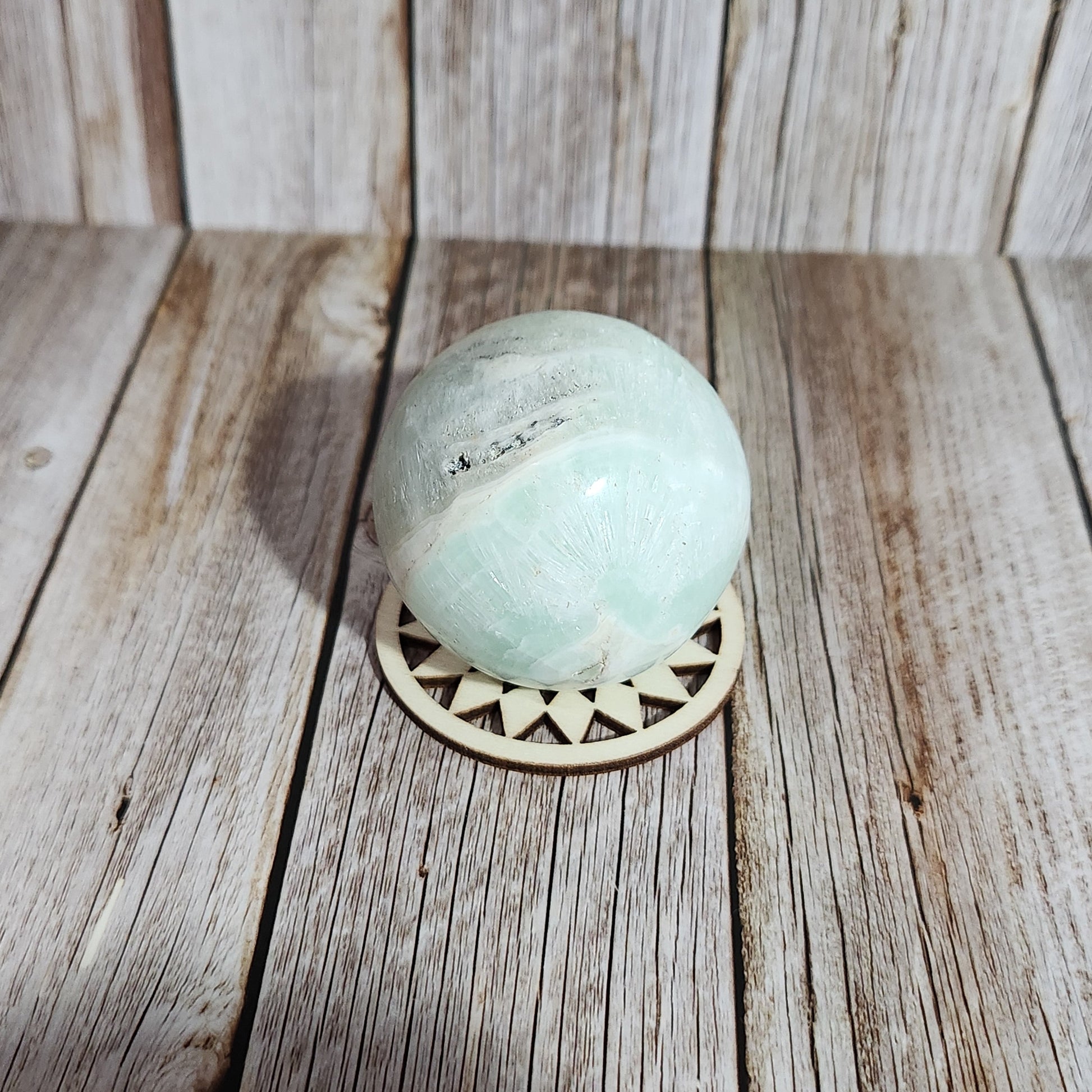 Light blue bath bomb on a wooden surface