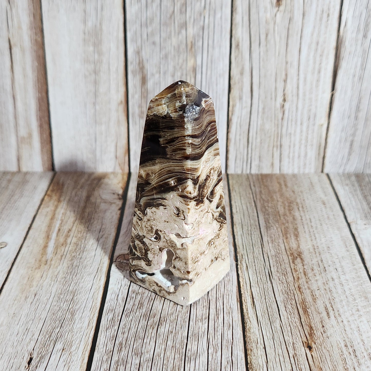 Polished crystal stone on a wooden surface