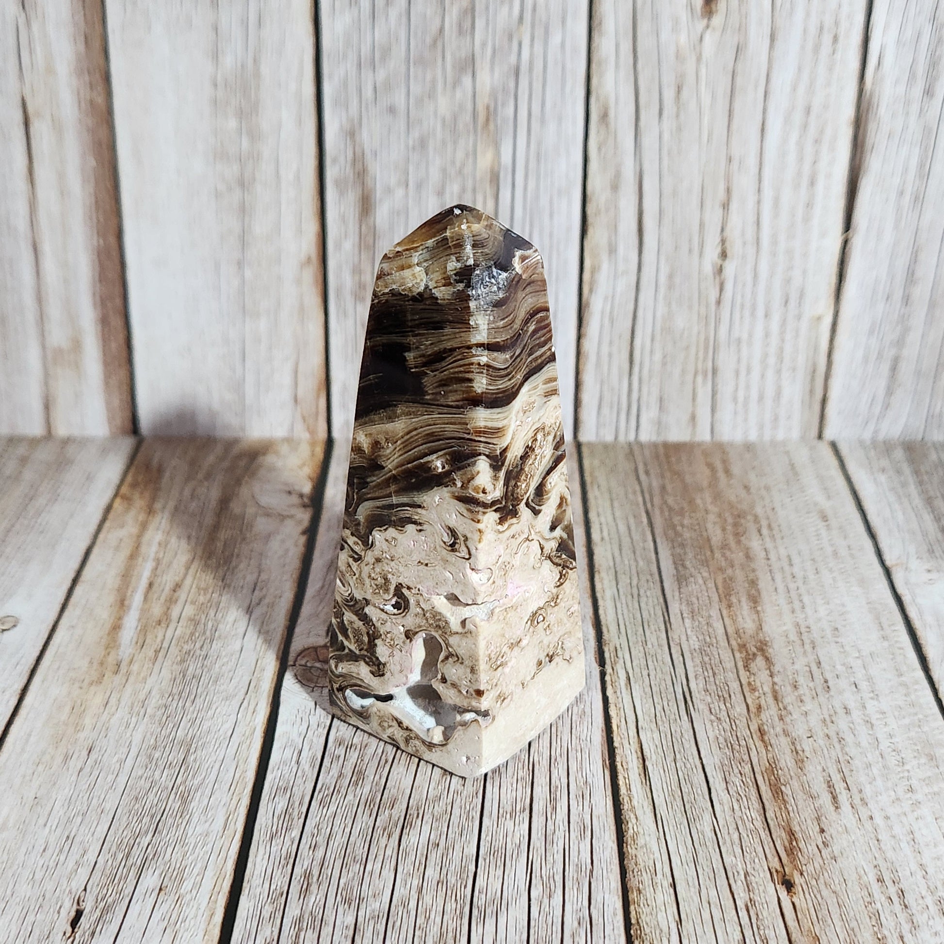 Polished crystal stone on a wooden surface