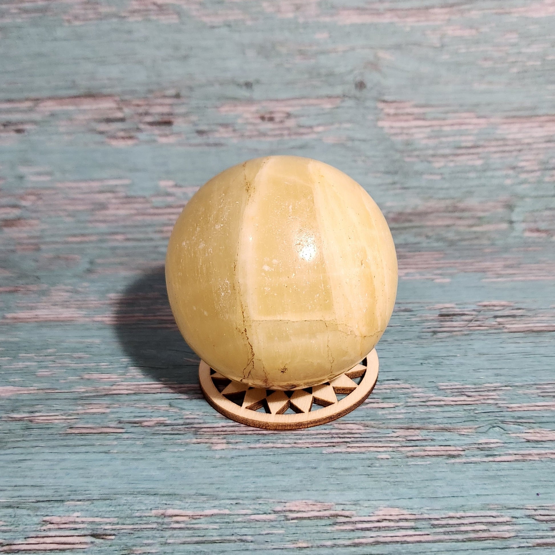 Wooden doorknob on a textured blue door